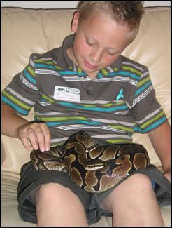 Child handling a snake