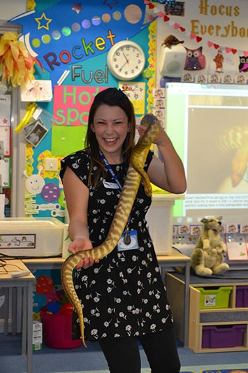 Teacher handling a snake